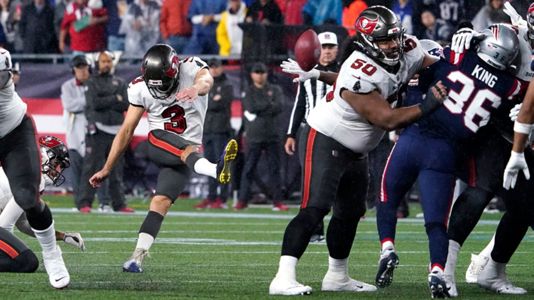 Tampa Bay Buccaneers quarterback Tom Brady (12) tosses the ball after being  taken down by New England Patriots nose tackle Davon Godchaux, right,  during the second half of an NFL football game