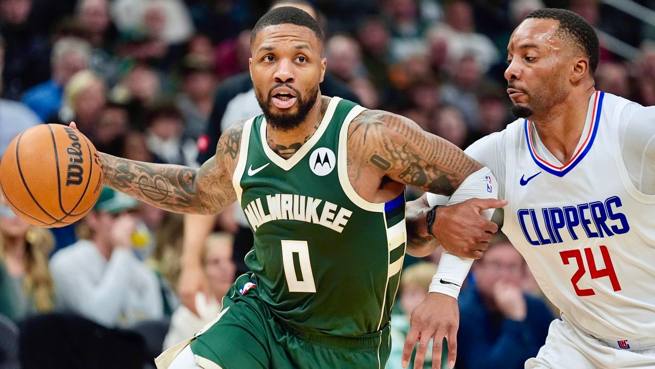 Milwaukee Bucks' Damian Lillard tries to get past Los Angeles Clippers' Norman Powell during the first half of an NBA basketball game Monday, March 4, 2024, in Milwaukee. (AP Photo/Morry Gash)