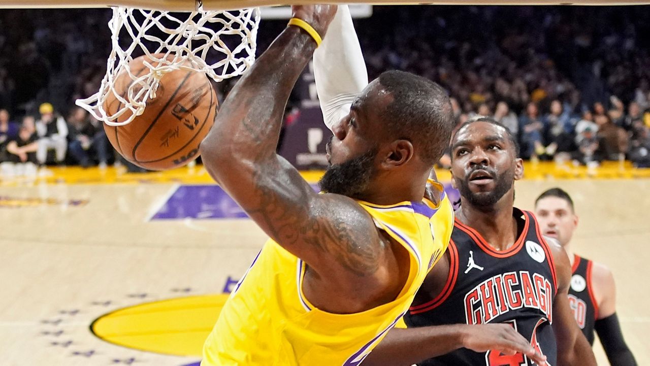 Los Angeles Lakers forward LeBron James, left, dunks as Chicago Bulls forward Patrick Williams defends during the first half of an NBA basketball game Thursday in LA. (AP Photo/Mark J. Terrill)