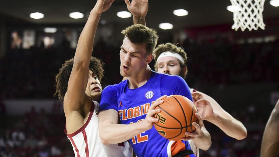 Florida forward Colin Castleton (12) tries to push past Oklahoma forward Jalen Hill, left, during the first half of an NCAA college basketball game in Norman, Okla., Wednesday, Dec. 1, 2021. (AP Photo/Kyle Phillips)