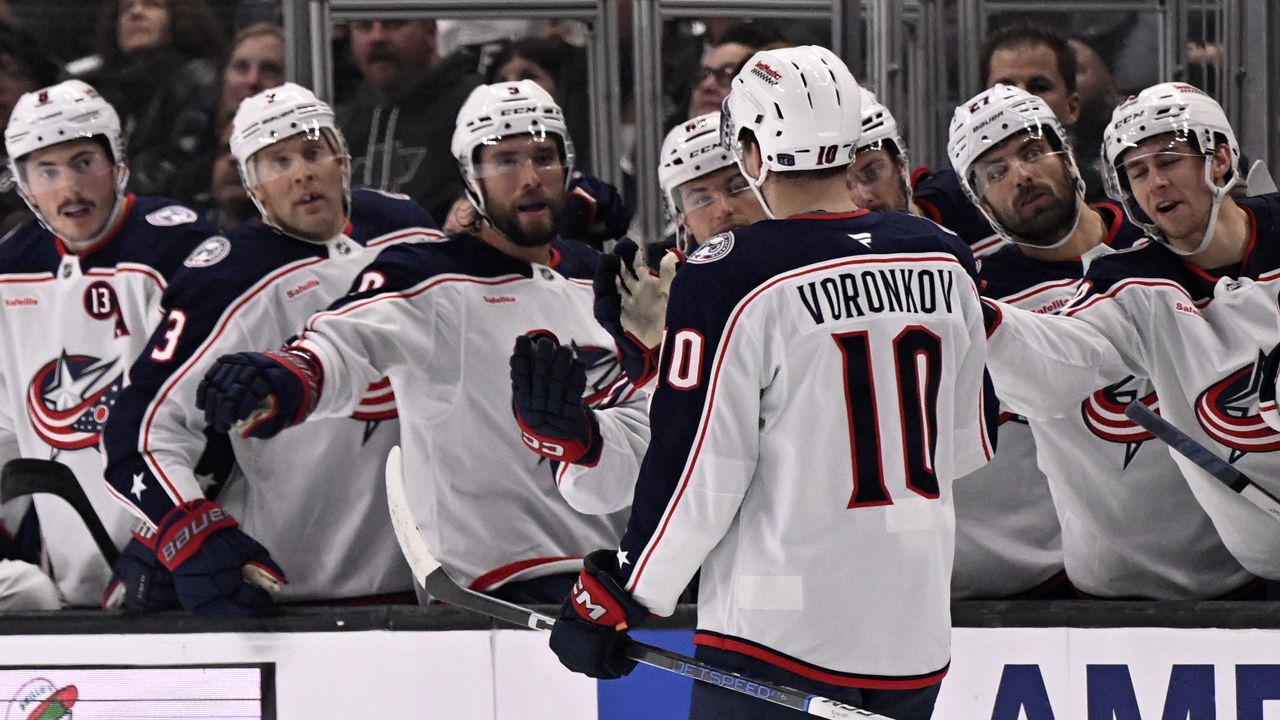 Columbus Blue Jackets left wing Dmitri Voronkov (10) celebrates after scoring a goal against the Los Angeles Kings with teammates on the bench during the first period of an NHL hockey game in Los Angeles, Saturday, Nov. 9, 2024. (AP Photo/Alex Gallardo)