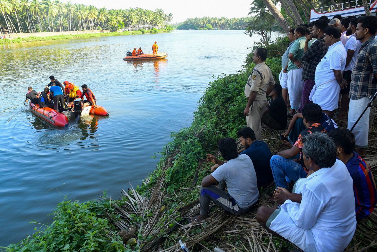 Fill in drive boat touristy monuments. A photo of a Rich man and a Boatman Crossing the River in a small Boat and the Boat Capsizes. Capsized.