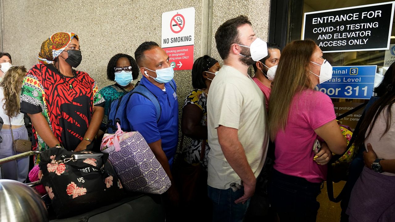 People in line to get COVID tested. (AP Images)