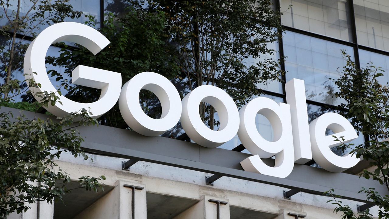 A Google sign hangs over an entrance to the company's new building, Sept. 6, 2023, in New York. (AP Photo/Peter Morgan, File)