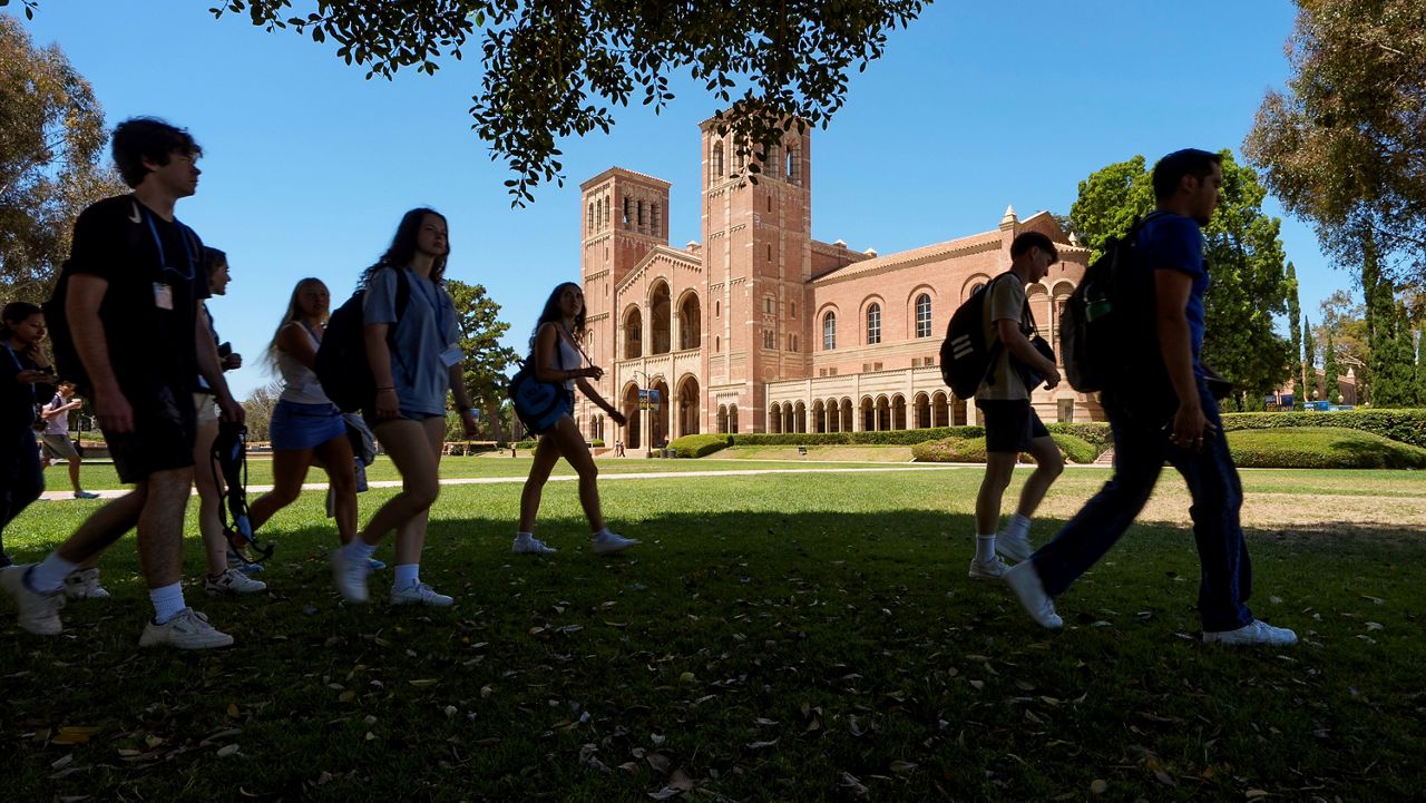 Students walk past Royce Hall at the University of California, Los Angeles, campus in Los Angeles, on Aug. 15, 2024. (AP Photo/Damian Dovarganes)