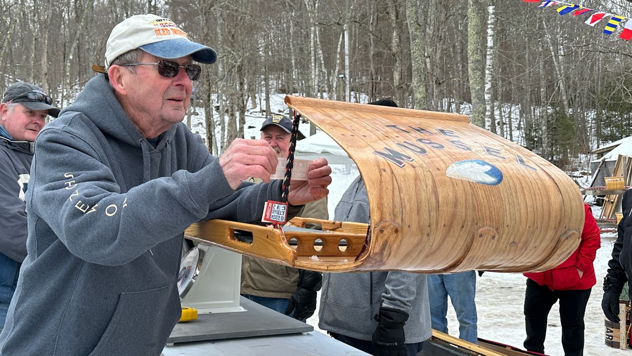 Toboggan inspector Tom Cox deems a sled ready to race Friday in advance of this weekend’s 33rd Annual U.S. National Toboggan Championships at the Camden Snow Bowl. (Spectrum News/Susan Cover)