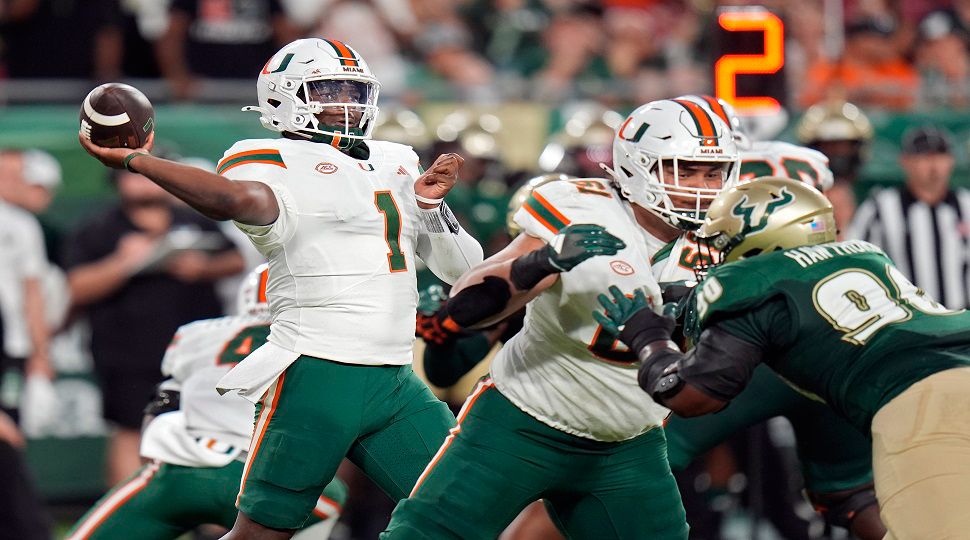 Miami quarterback Cam Ward (1) throws a pass against South Florida during the first half of an NCAA college football game Saturday, Sept. 21, 2024, in Tampa, Fla. (AP Photo/Chris O'Meara)