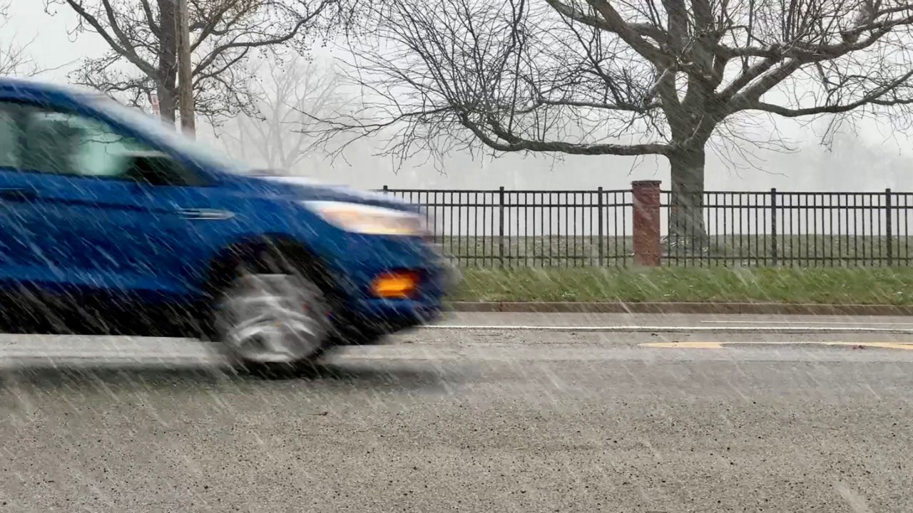 A car drives through the snow in Fairborn, Ohio. 