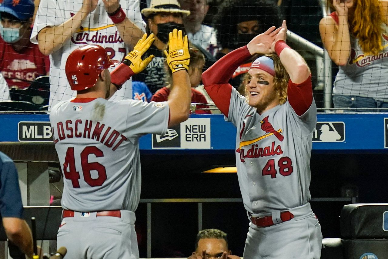 Wearing Clemente's No. 21, Molina homers for Cards in opener