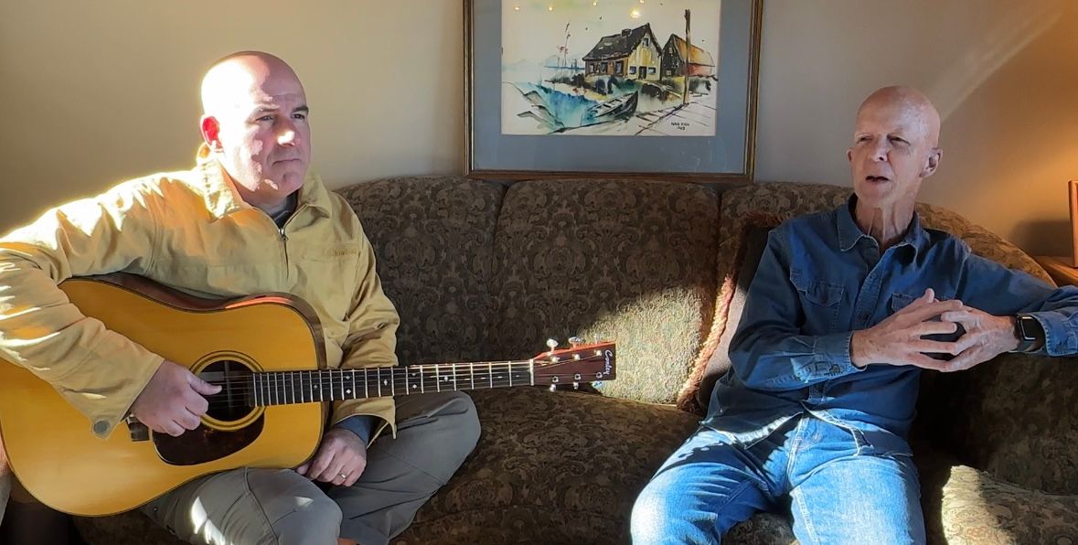 Musicians Jason Carey, left, and Scott Fish, right, wrote a song urging Mainers to keep the current state flag. (Spectrum News/Susan Cover)