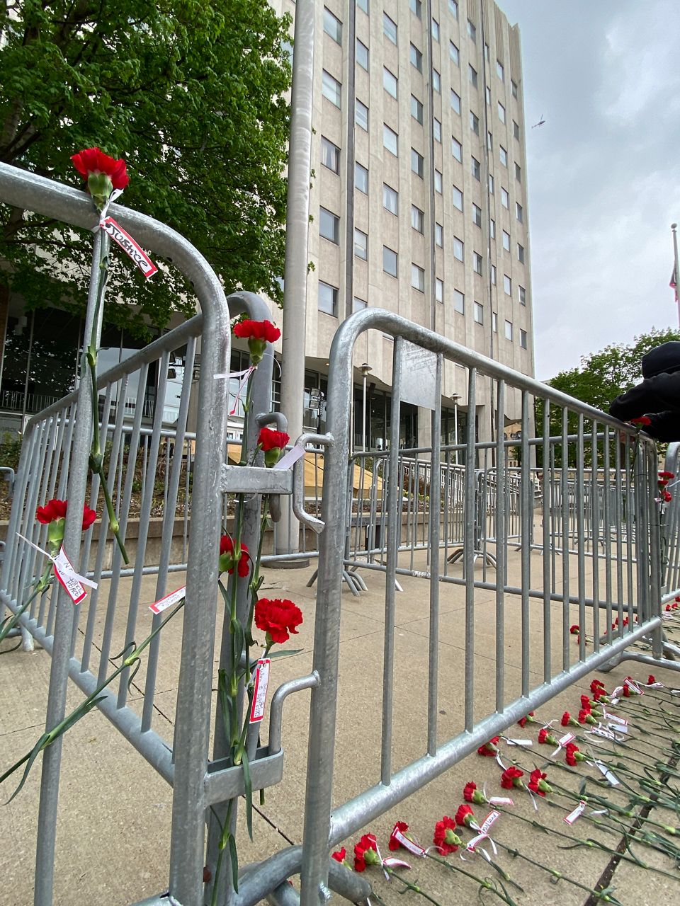 Protesters leave carnations at Akron Police headquarters