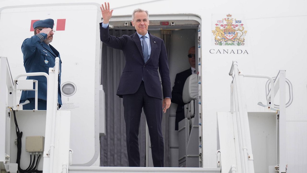 Canadian Prime Minister Mark Carney boards a government plane in Ottawa, Ontario, Monday, May 5, 2025, en route to Washington for a meeting with U.S. President Donald Trump on Tuesday. (Adrian Wyld/The Canadian Press via AP)