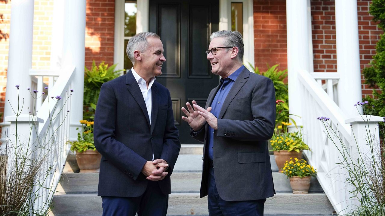 Prime Minister Mark Carney greets British Prime Minister Kier Starmer, outside his residence at Rideau Cottage in Ottawa, on Saturday, June 14, 2025, for a visit before the G7 Summit. (Justin Tang/The Canadian Press via AP)