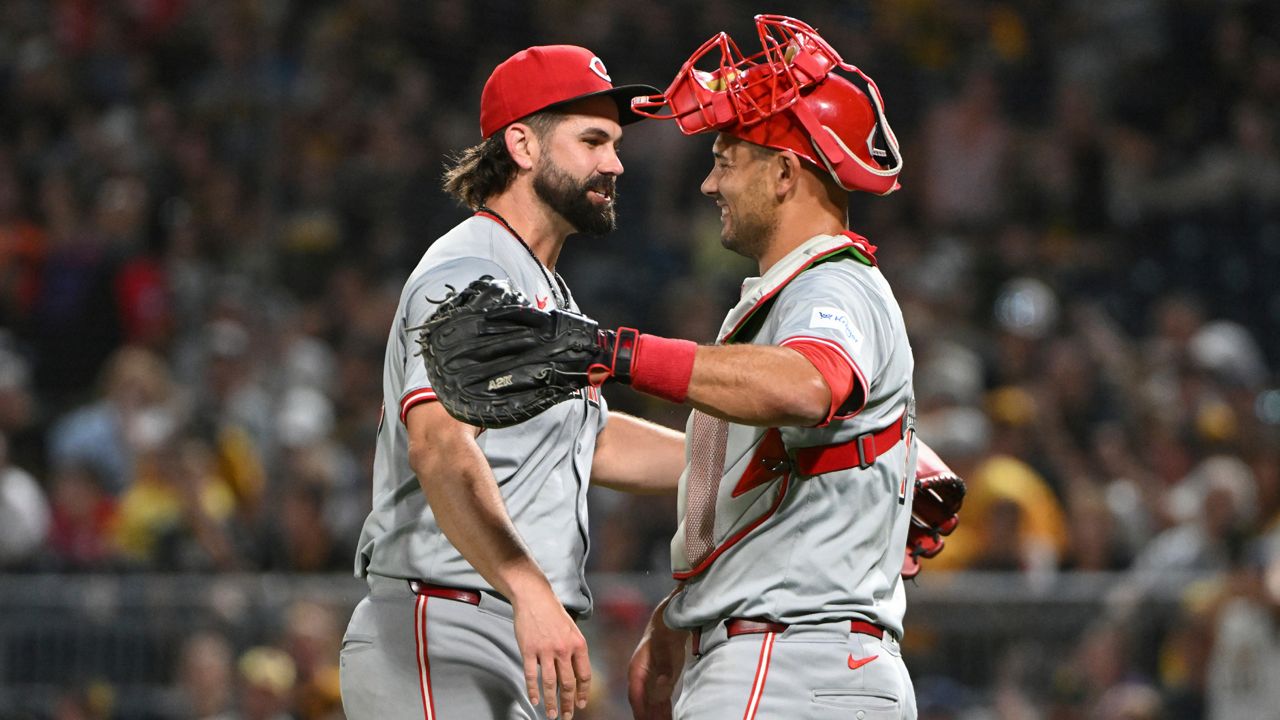 Cincinnati Reds relief pitcher Casey Kelly celebrates with catcher Luke Maile after defeating the Pittsburgh Pirates 10-2 during a baseball game, Saturday, Aug. 24, 2024, in Pittsburgh.