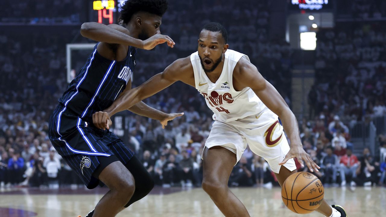 Cleveland Cavaliers forward Evan Mobley (4) drives against Orlando Magic forward Jonathan Isaac, left, during the first half of Game 2 of an NBA basketball first-round playoff series, Monday, April 22, 2024, in Cleveland. (AP Photo/Ron Schwane)