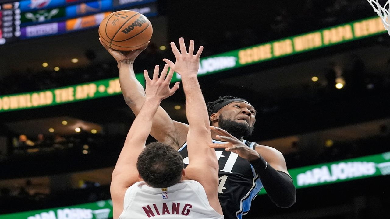 Atlanta Hawks forward Bruno Fernando (24) scores as Cleveland Cavaliers forward Georges Niang (20) defends during the first half of an NBA basketball game Wednesday, March 6, 2024, in Atlanta. (AP Photo/John Bazemore)