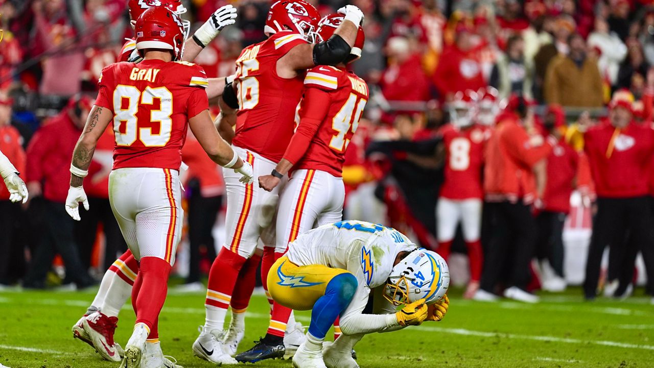 Los Angeles Chargers linebacker Troy Dye (43) reacts as Kansas City Chiefs kicker Matthew Wright (49) is congratulated by teammates after making a game-winning field goal as time expires in an NFL football game Sunday, Dec. 8, 2024, in Kansas City, Mo. (AP Photo/Charlie Riedel)