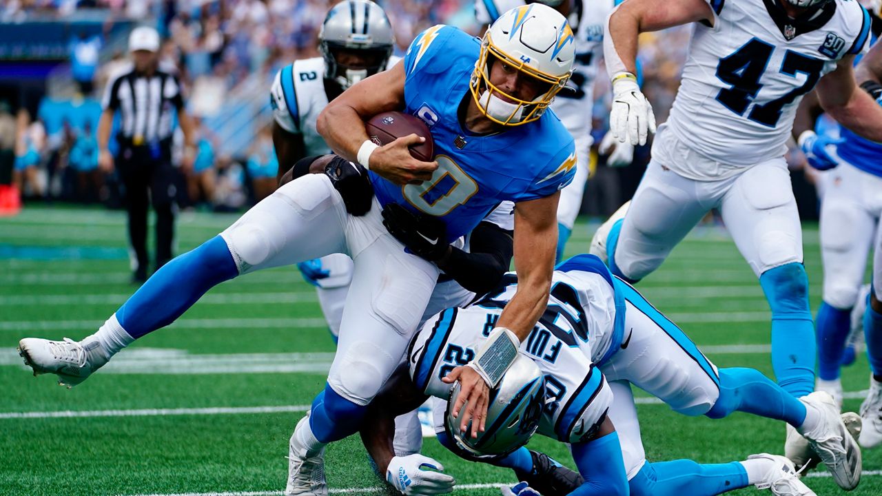 Los Angeles Chargers quarterback Justin Herbert runs against the Carolina Panthers during the first half of an NFL football game on Sunday, Sept. 15, 2024, in Charlotte, N.C. (AP Photo/Erik Verduzco)