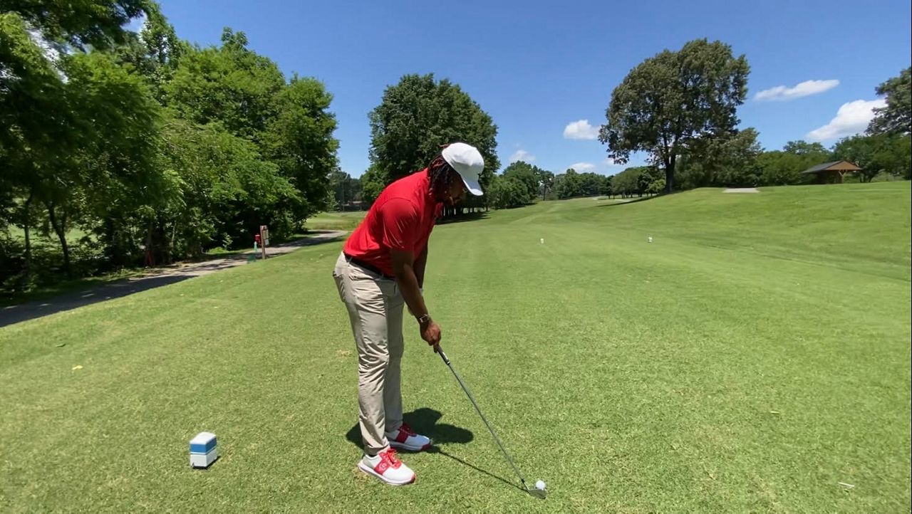 Charles Penny tees off on the Gillespie Golf Course in Greensboro. (Spectrum News 1/Zyneria Byrd)