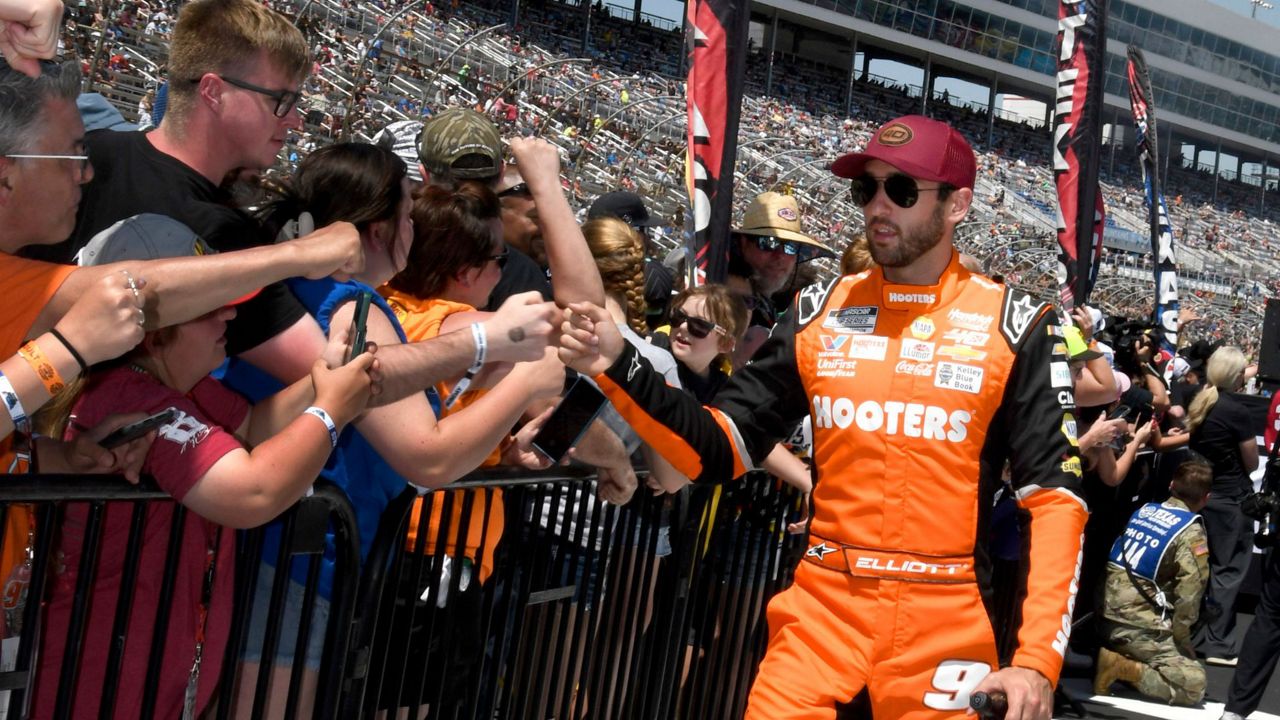 Chase Elliott, right, greets fans during driver introductions before a NASCAR Cup Series auto race at Texas Motor Speedway in Fort Worth, Texas, Sunday, April 14, 2024. (AP Photo/Randy Holt)