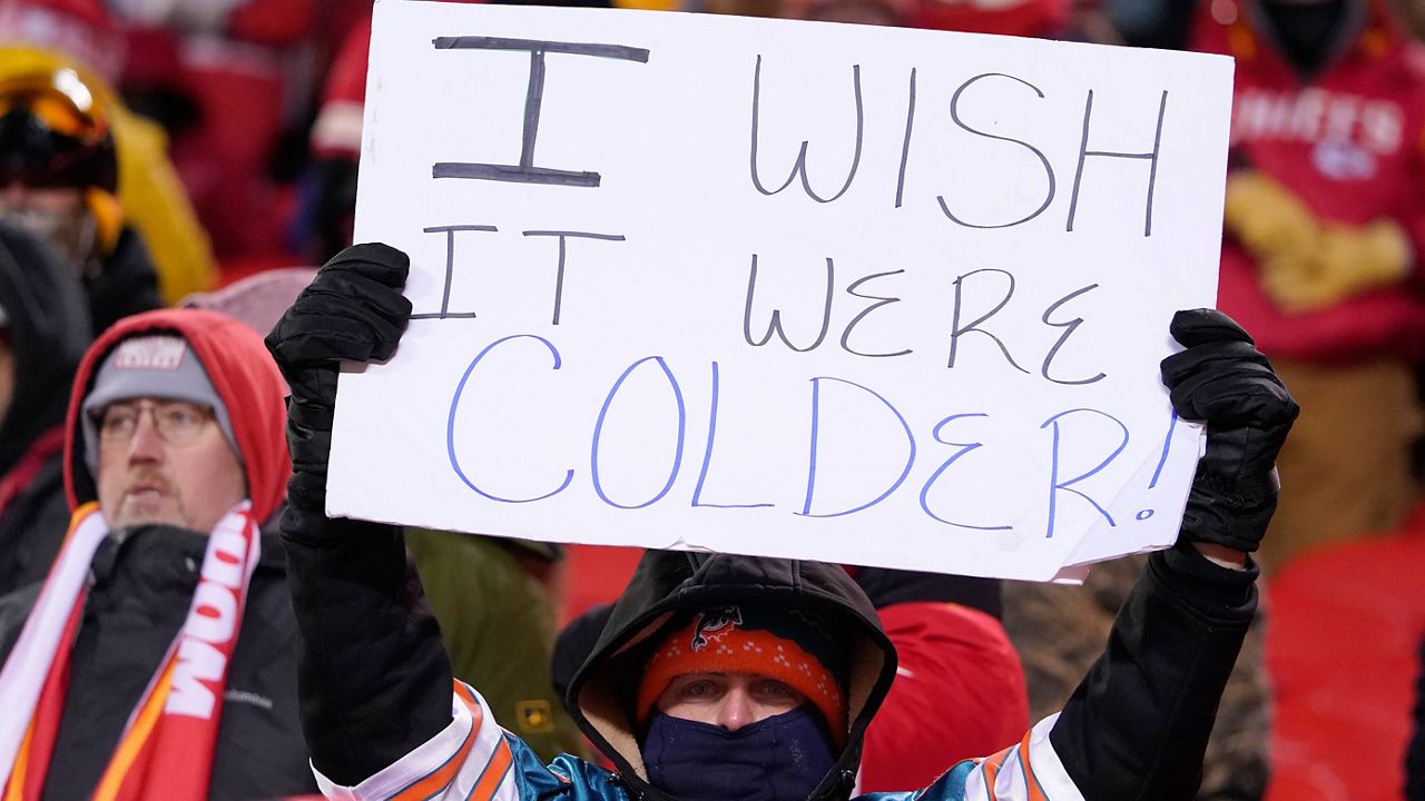 A fan holds up a sign before an NFL wild-card playoff football game between the Kansas City Chiefs and the Miami Dolphins on Saturday, Jan. 13, 2024, in Kansas City, Mo. (AP Photo/Ed Zurga)