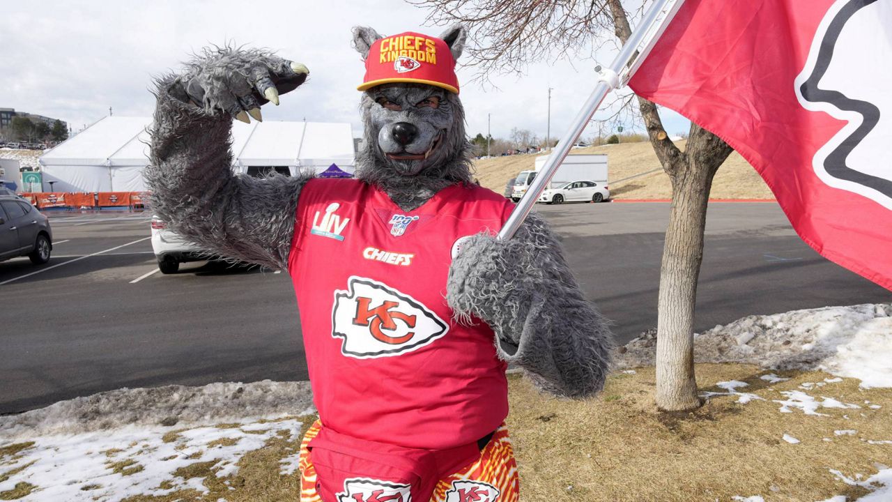 A Kansas City Chiefs fan, Chiefsaholic, poses for photos while walking toward Empower Field at Mile High before an NFL football game between the Denver Broncos and the Chiefs, Jan. 8, 2022, in Denver. An Oklahoma judge has ordered the Kansas City Chiefs superfan known as “ChiefsAholic” who admitted to a series of bank robberies to pay $10.8 million to a bank teller he threatened and assaulted with a gun. (AP Photo/David Zalubowski, file)