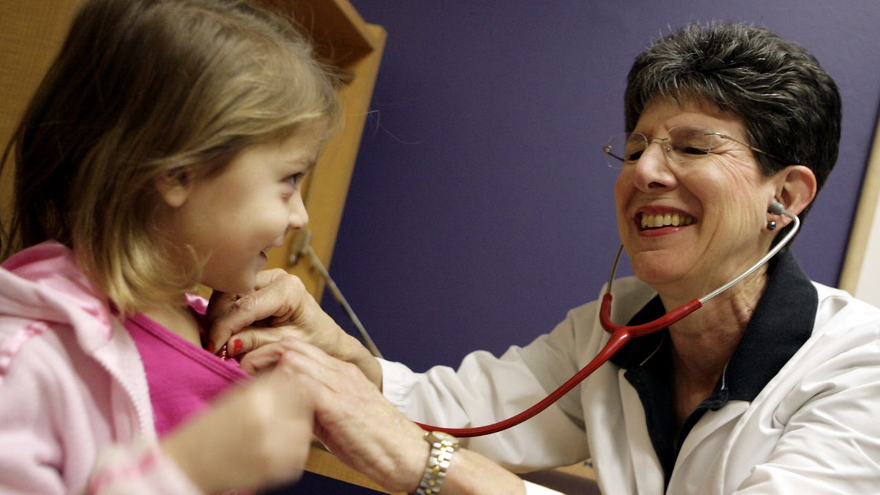 Dr. Jane Rider, a pediatrician in San Angelo, Texas, listens to the heart beat of Kailyn Ponce, 3, in her office Oct. 27, 2006. (AP Photo/Patrick Dove)