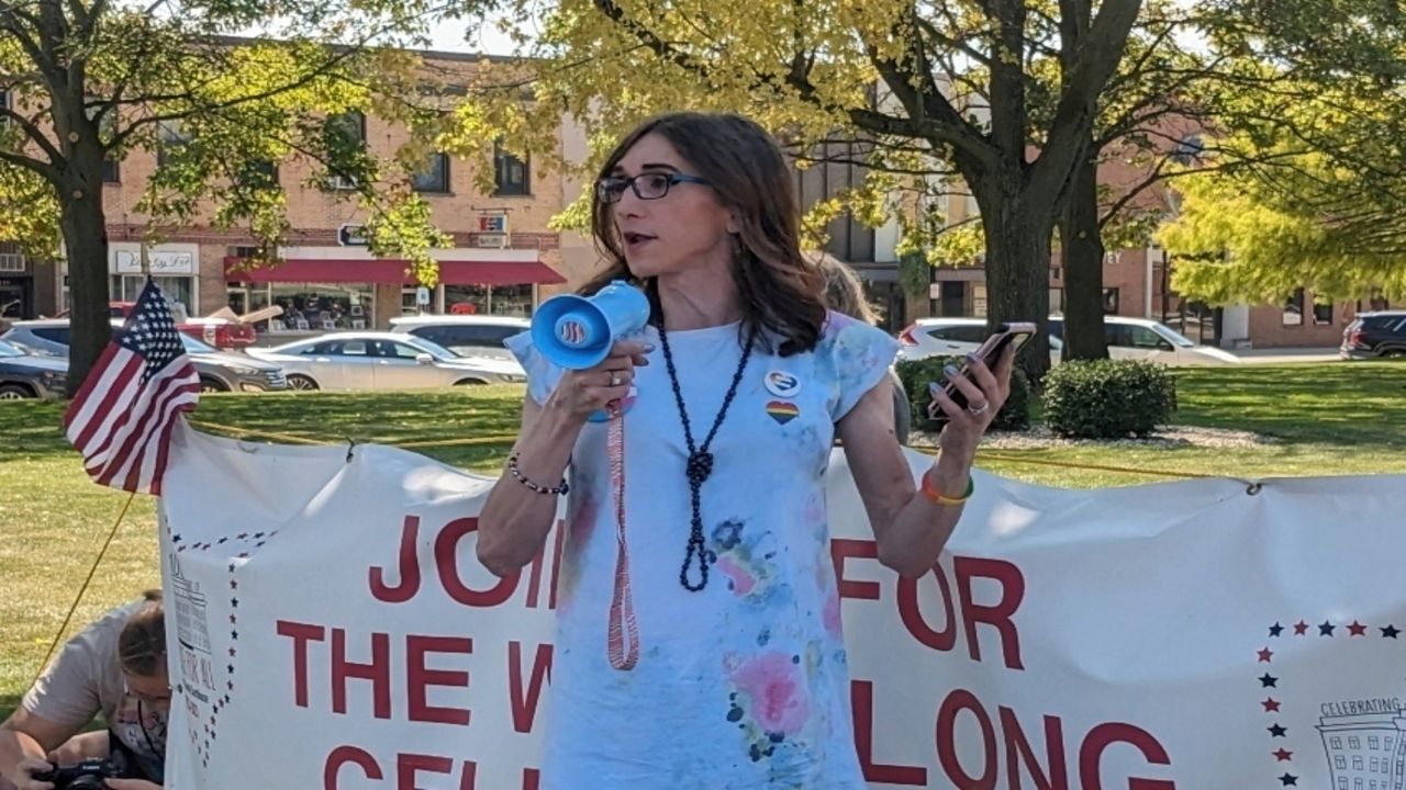 In this undated photo provided by Arienne Childrey, Childrey speaks into a megaphone outside of Mercer County Courthouse in Celina, Ohio, during a protest of the Ohio Drag Ban.