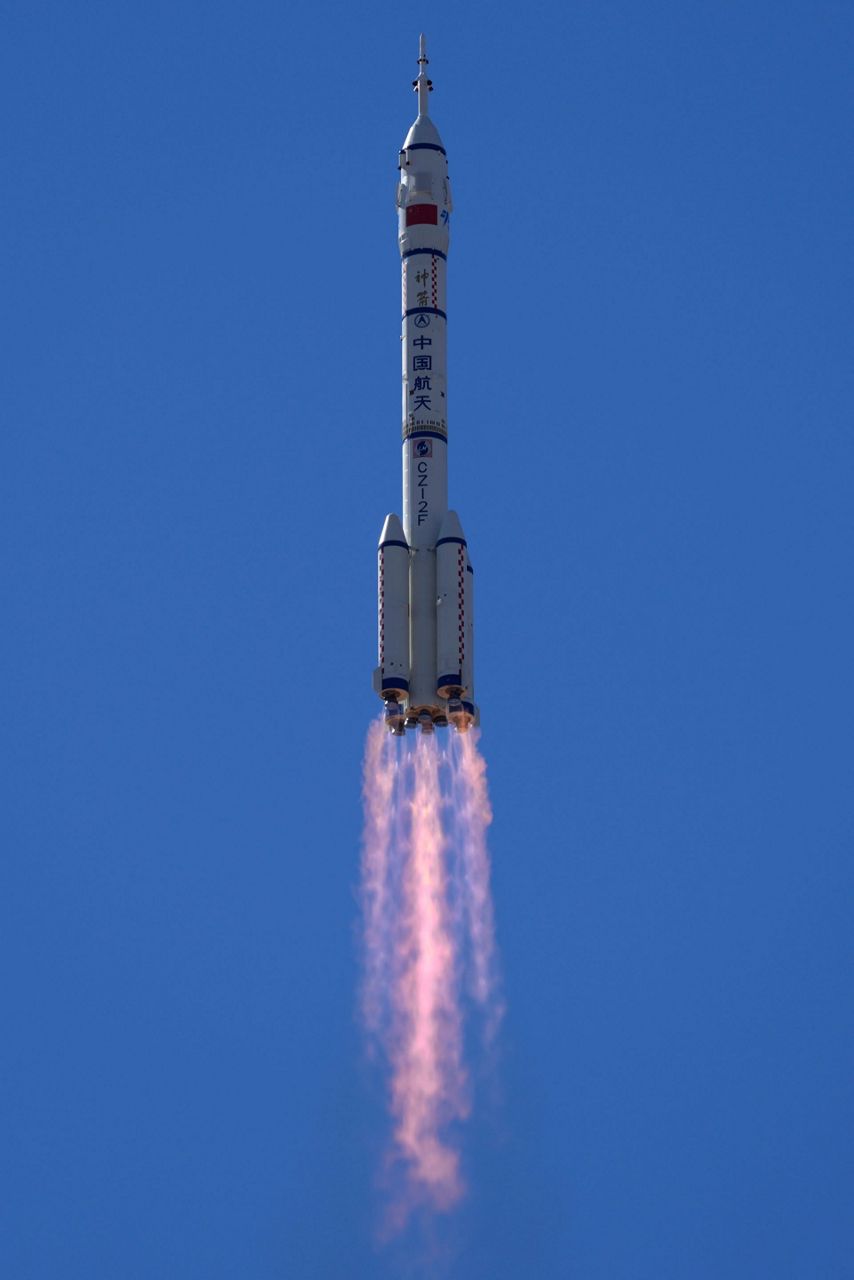 China launches first three-man crew to new space station