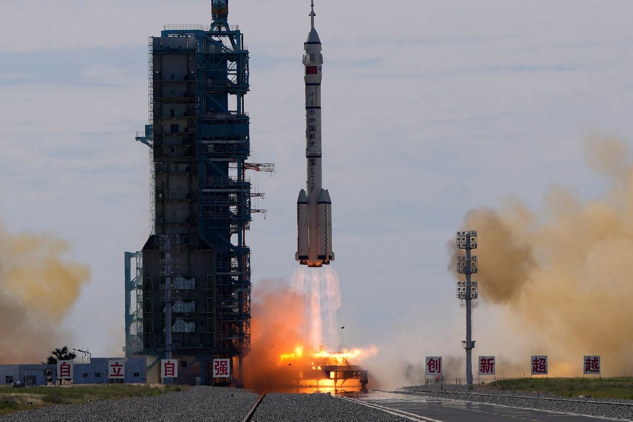 China launches first three-man crew to new space station