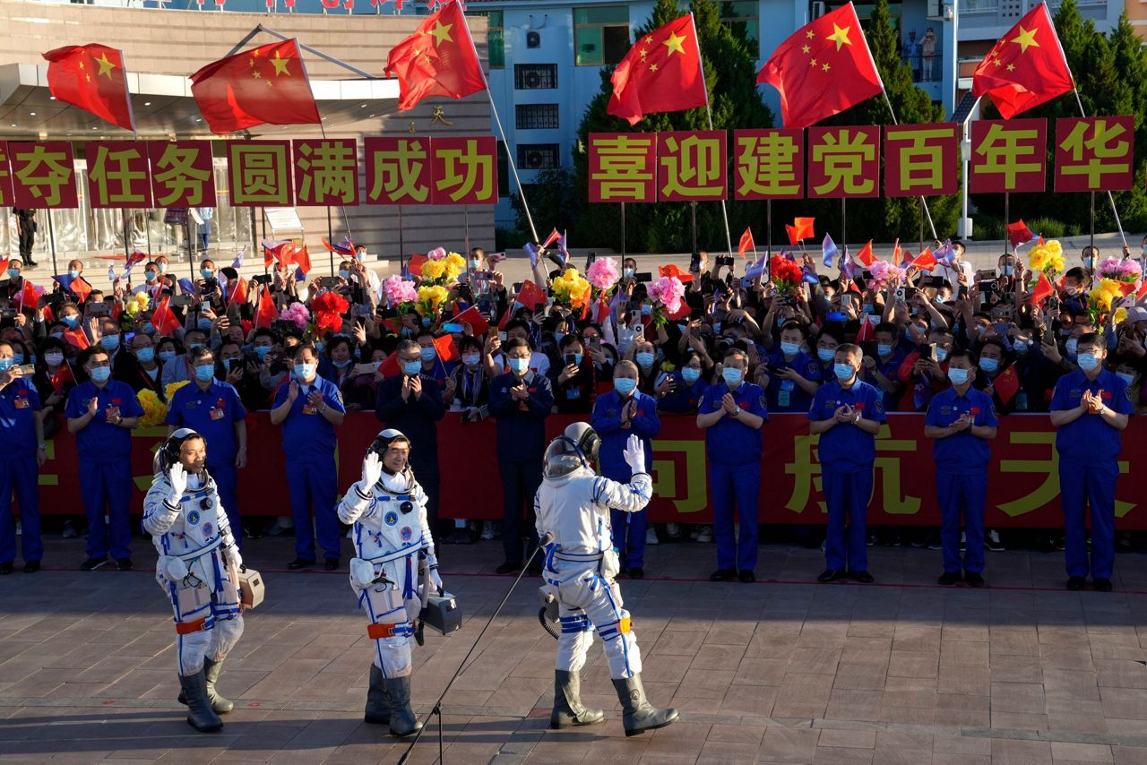 China launches first three-man crew to new space station