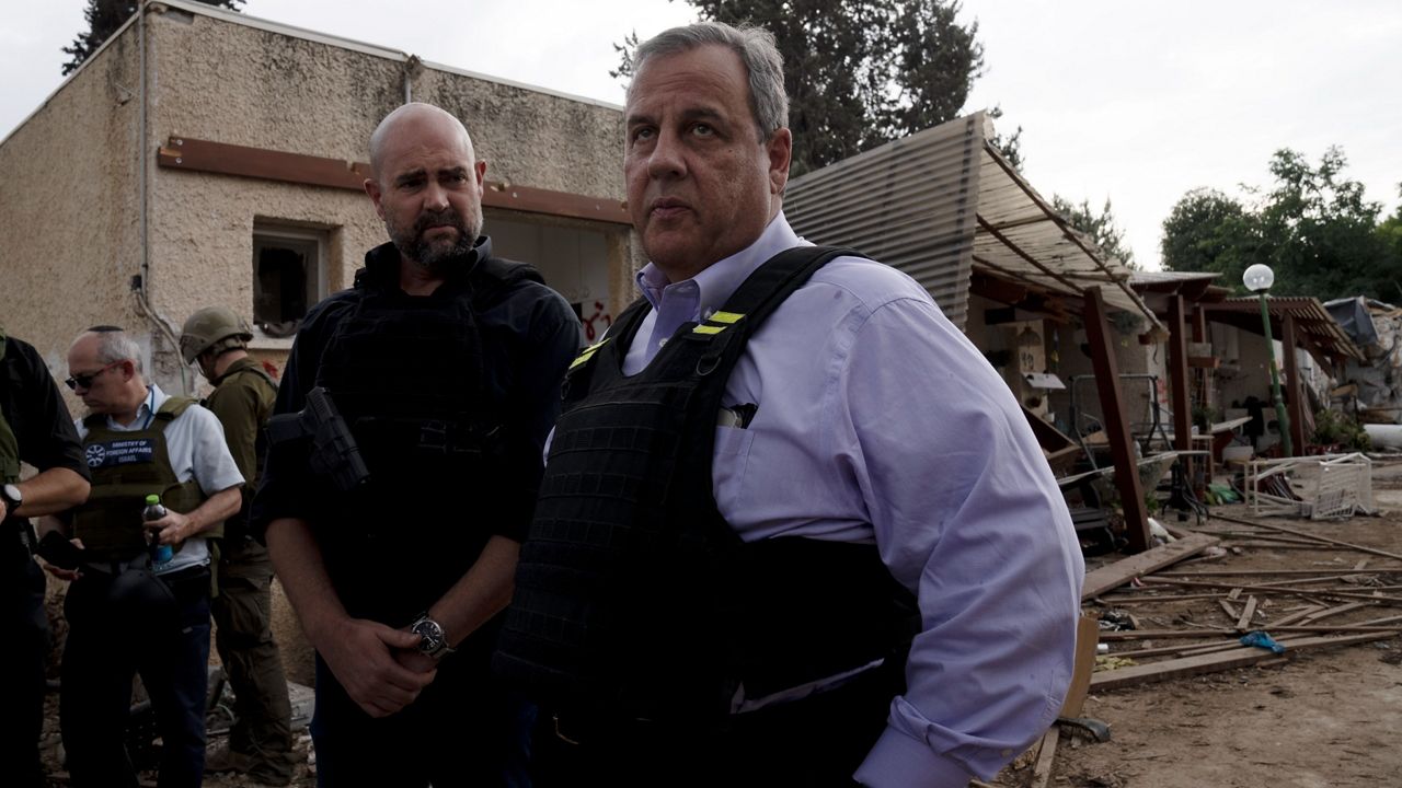 Former New Jersey Governor Chris Christie, right, makes remarks at the end of a visit to Kibbutz Kfar Azza, near the Israel-Gaza Border, the site of an Oct. 7 massacre by Hamas, with Israel's Knesset Speaker Amir Ohana, left, Sunday, Nov. 12, 2023. (AP Photo/Maya Alleruzzo)