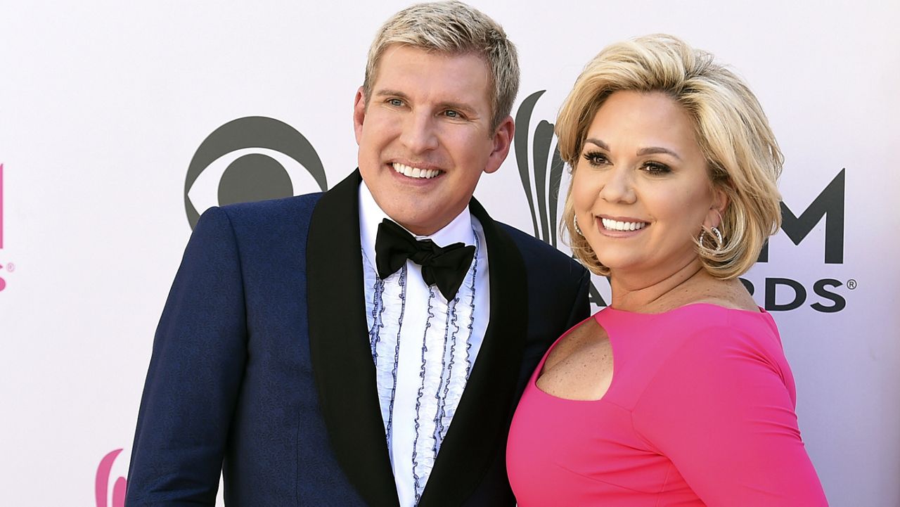 Julie Chrisley, right, and her husband Todd Chrisley pose for photos at the 52nd annual Academy of Country Music Awards on April 2, 2017, in Las Vegas. (Jordan Strauss/Invision/AP, File)