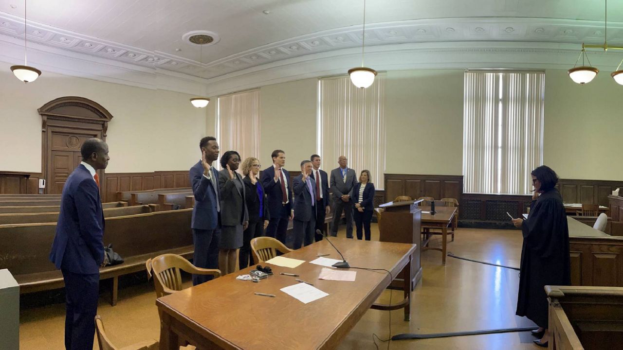 St. Louis Circuit Attorney Gabe Gore (left) looks on as six U.S. attorneys are sworn in to serve as homicide prosecutors in the Circuit Attorney's Office. The lawyers will continue to handle their federal caseloads. (Courtesy: St. Louis Circuit Attorney's Office)
