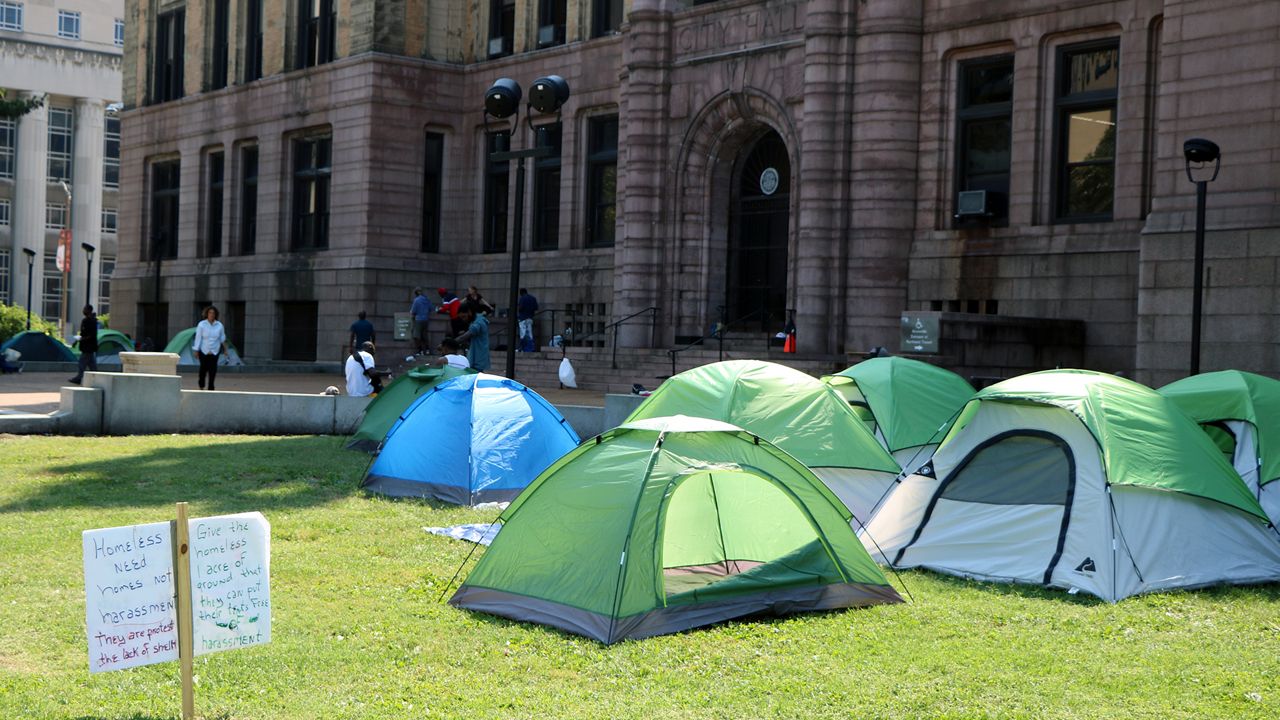 A homeless encampment is located right outside St. Louis City Hall off Market Street. Alongside the tents are signs advocating for a homeless bills of rights and more. (Spectrum News/Elizabeth Barmeier)