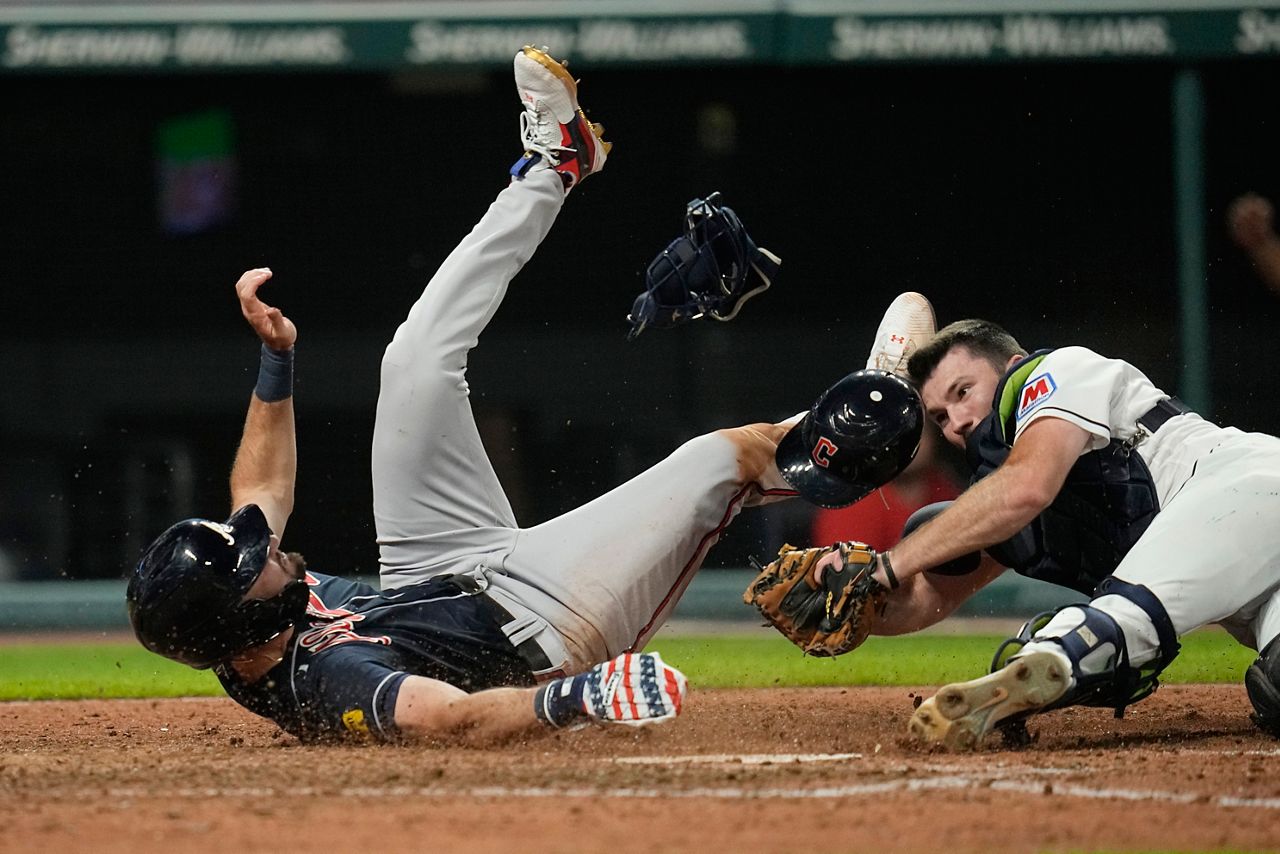 baseball players falling at home plate