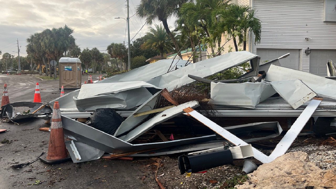 A pile of debris from the EF1 tornado sits across from Carlouel Yacht Club in Clearwater, Fla.