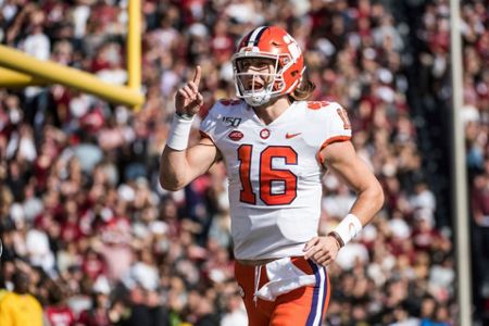 Clemson Tigers quarterback Trevor Lawrence (16) celebrates with running  back Travis Etienne (9) during an NCAA