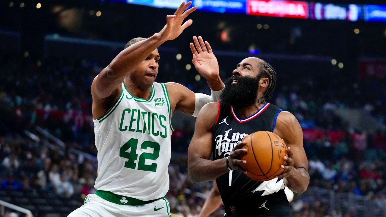 Los Angeles Clippers guard James Harden (1) drives against Boston Celtics center Al Horford (42) during the first half of an NBA basketball game in Los Angeles, Saturday, Dec. 23, 2023. (AP Photo/Eric Thayer)