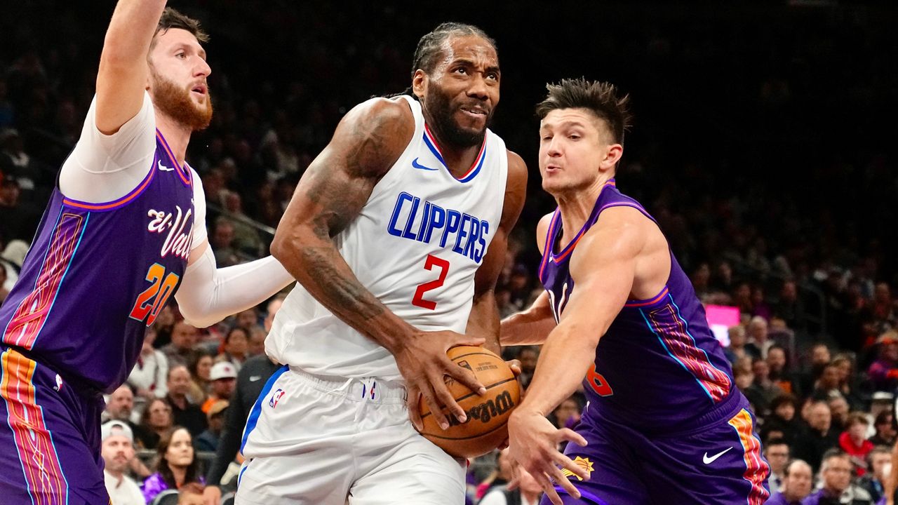 Los Angeles Clippers forward Kawhi Leonard (2) drives past Phoenix Suns guard Grayson Allen, right, and center Jusuf Nurkic (20) during the first half of an NBA basketball game Wednesday, Jan. 3, 2024, in Phoenix. (AP Photo/Ross D. Franklin)