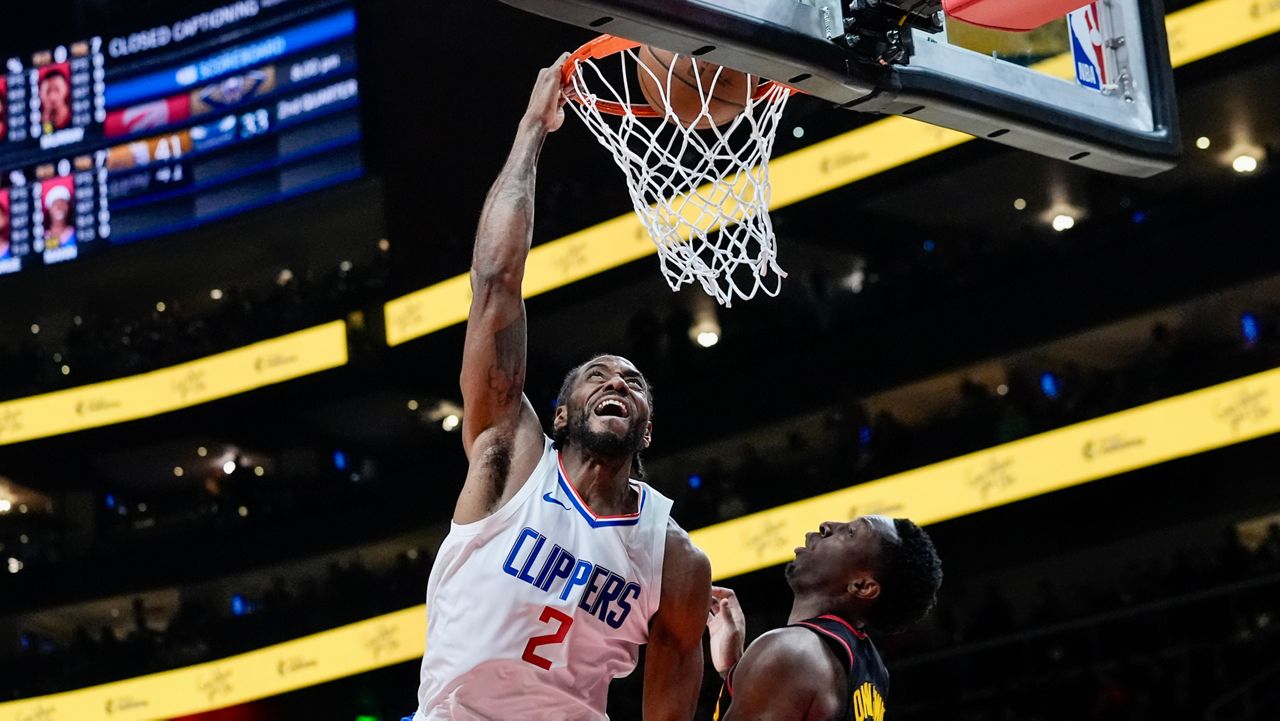 LA Clippers forward Kawhi Leonard (2) goes up for a basket as Atlanta Hawks forward Onyeka Okongwu (17) defends during the first half of an NBA basketball game Monday, Feb. 5, 2024, in Atlanta. (AP Photo/John Bazemore)