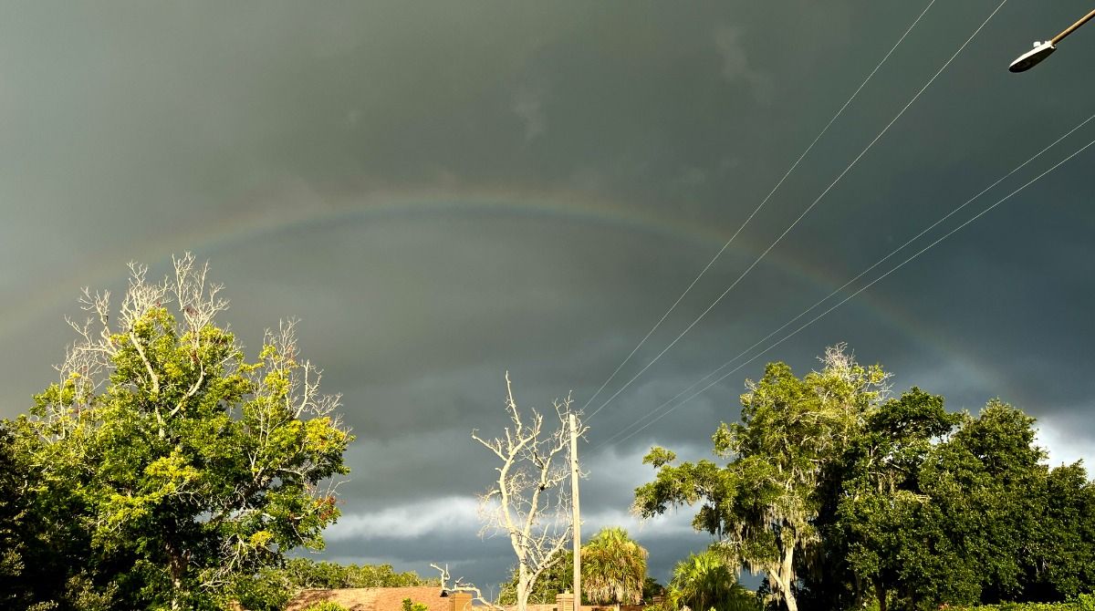 Rainbow in dark, cloudy skies