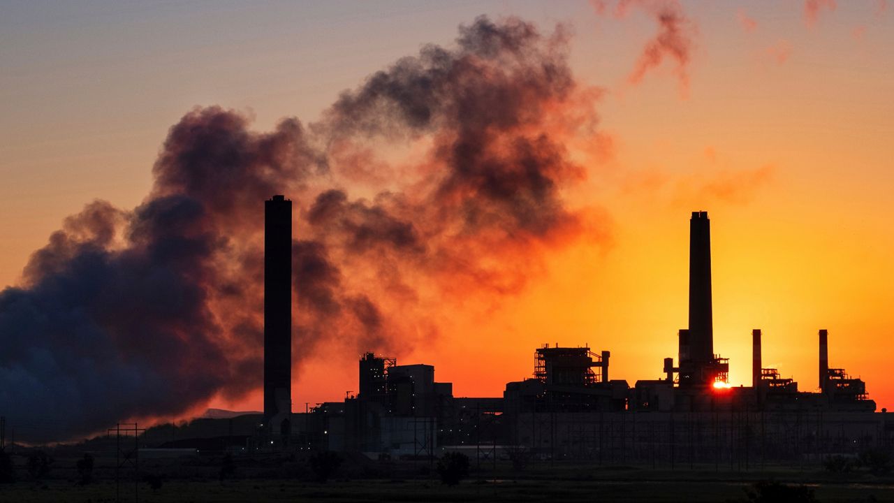 In this July 27, 2018, file photo, the Dave Johnson coal-fired power plant is silhouetted against the morning sun in Glenrock, Wyo. (AP Photo/J. David Ake, File)