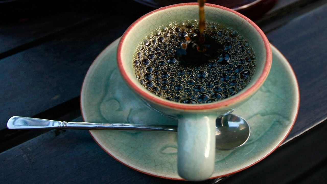 In this photo taken Dec. 3, 2012, the $1,100 per kilogram ($500 per pound) Black Ivory coffee is poured into a cup at a hotel restaurant in Chiang Rai province, northern Thailand. (AP Photo/Apichart Weerawong)