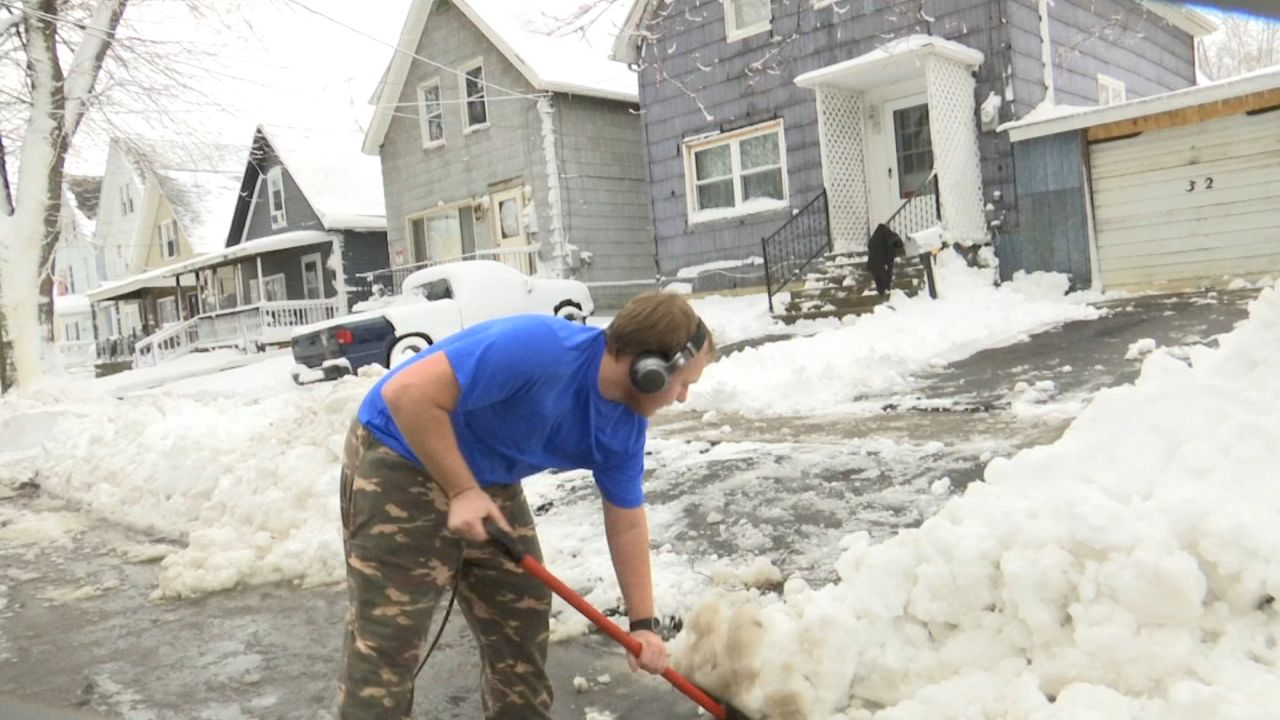 Man shoveling in a T-shirt