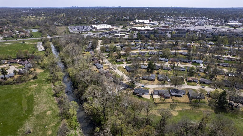 Coldwater Creek flows Friday, April 7, 2023, in Florissant, Mo. The creek was contaminated when nuclear waste from the Manhattan Project flowed into the waterway past homes, schools and businesses. St. Louis played an important role in the country’s effort to build the first nuclear weapon. (AP Photo/Jeff Roberson)