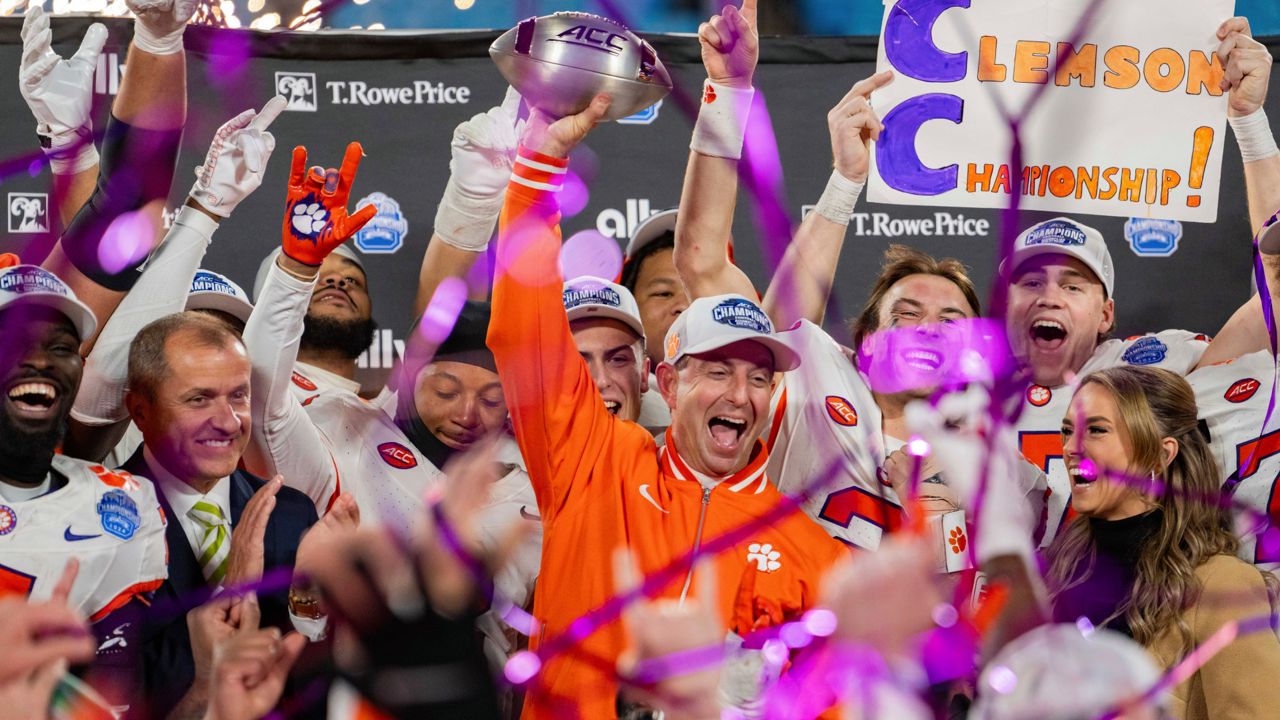 Clemson head coach Dabo Swinney celebrates with the trophy after defeating SMU during the Atlantic Coast Conference championship NCAA college football game Saturday, Dec. 7, 2024, in Charlotte, N.C.