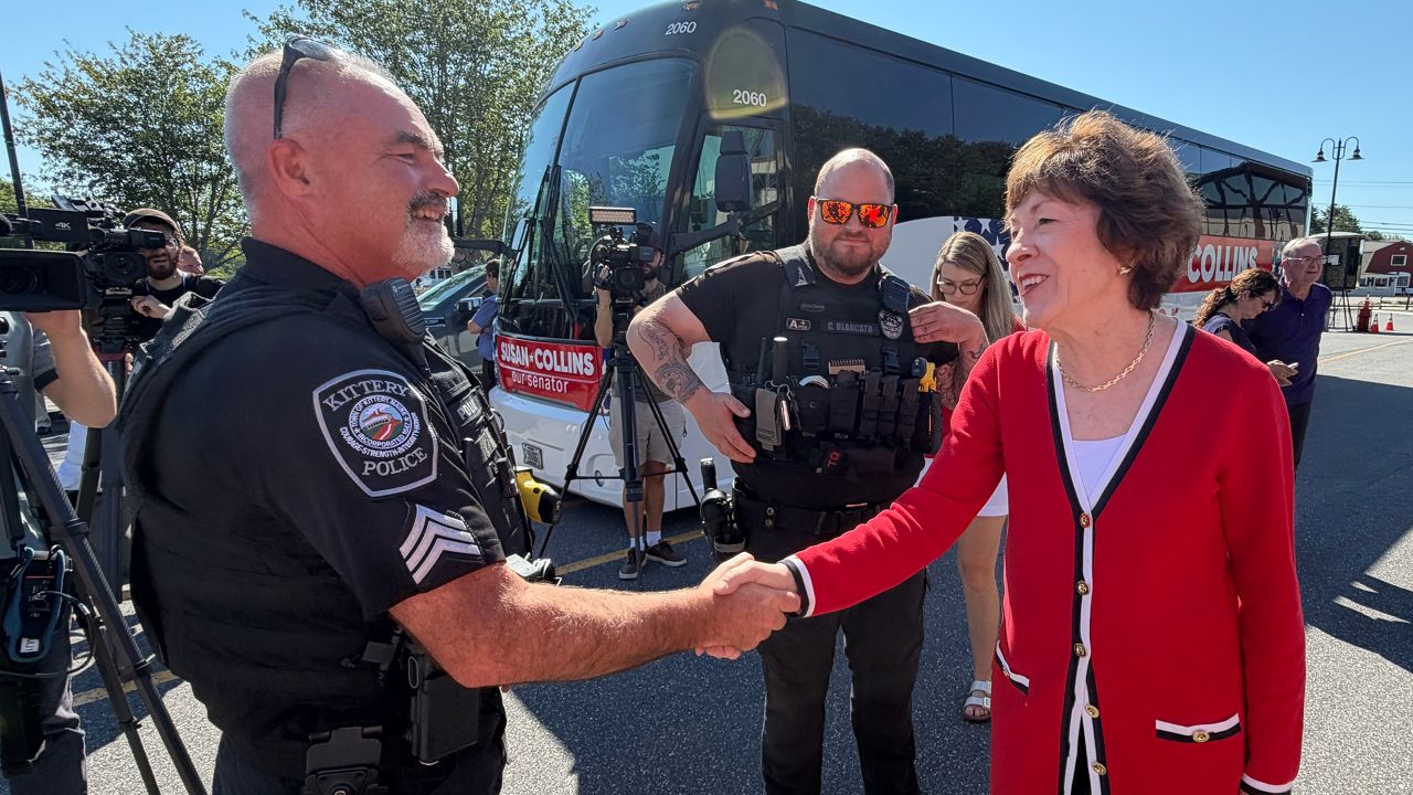 Sen. Susan Collins greets a Kittery police officer on Friday. (Spectrum News/Susan Cover)