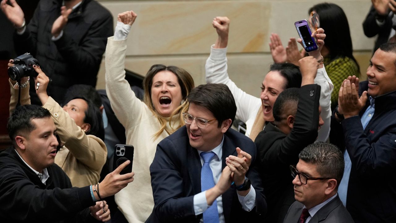 Miguel Uribe Turbay, center in blue tie, a Colombian senator and presidential candidate for the right-wing Centro Democrático party, celebrates after voting against a labor reform referendum proposed by the government, in Bogota, Colombia, May 14, 2025. (AP Photo/Fernando Vergara, File)