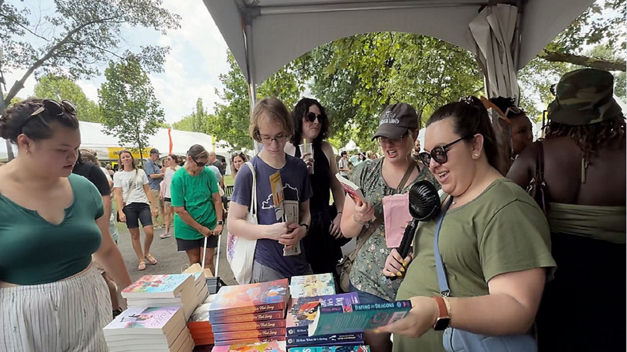 Attendees browse books at the Columbus Book Festival on Saturday, July 12, 2025, in downtown Columbus. (Spectrum News 1/Saima Khan)